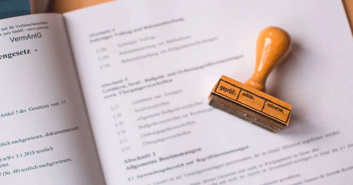 A wooden stamp resting on an open book