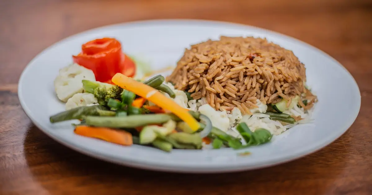 A plate of rice with mixed vegetables