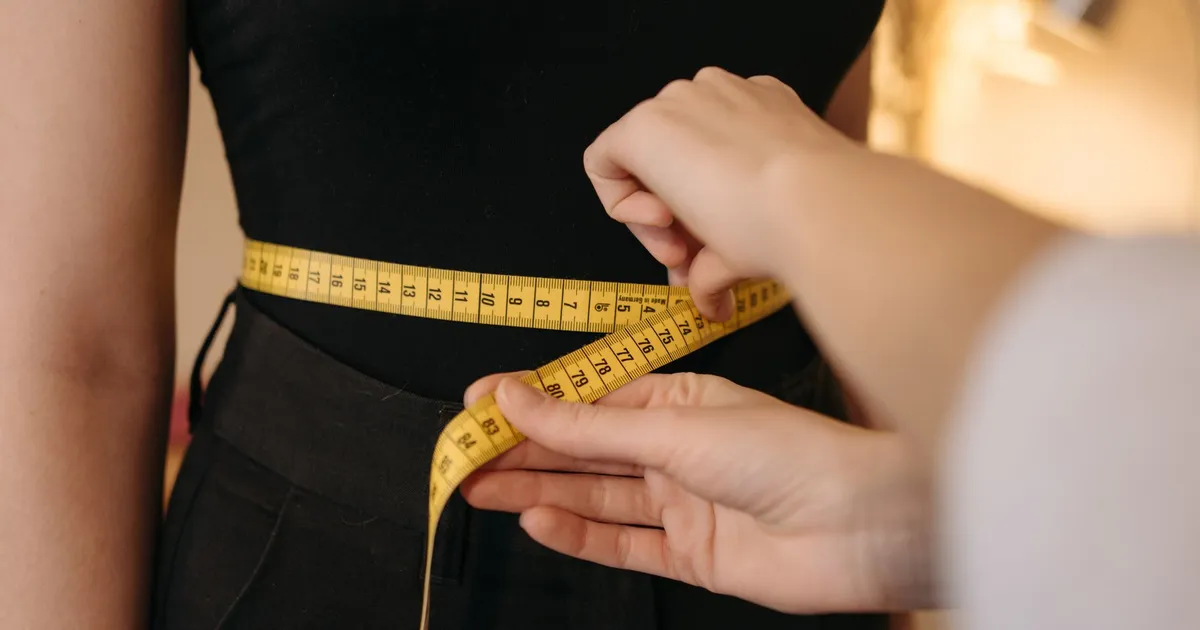 A tape measure around a person's waist