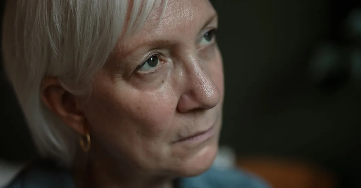 Close-up portrait of a woman in her sixties with grey hair