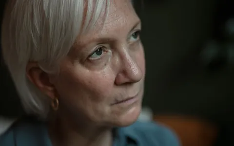 Close-up portrait of a woman in her sixties with grey hair