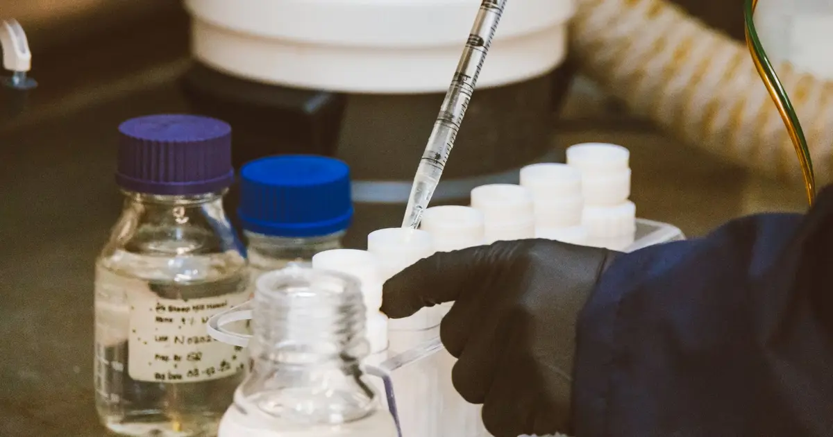 Detailed view of laboratory equipment and pipette in use, enhancing scientific research