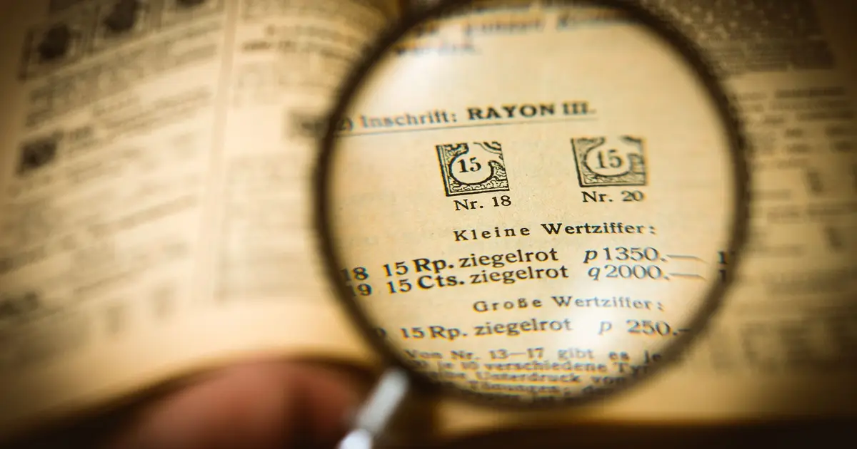 Detailed view of a book page magnified by a glass, enhancing text clarity