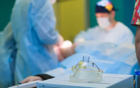 Medical team performing surgery in a sterile hospital operating room