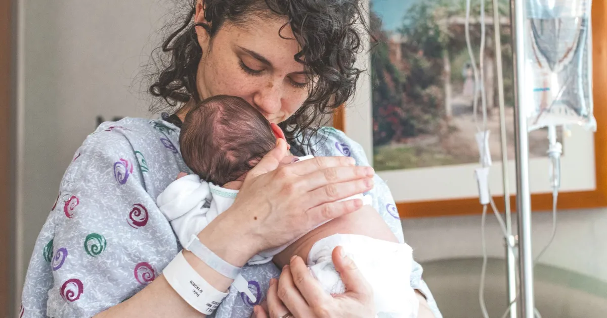 A mother holding her newborn baby in hospital