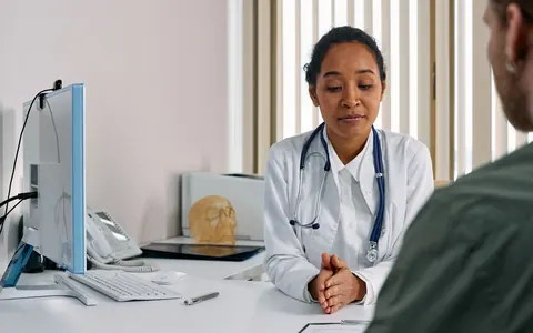 A doctor talking with a patient in a medical office