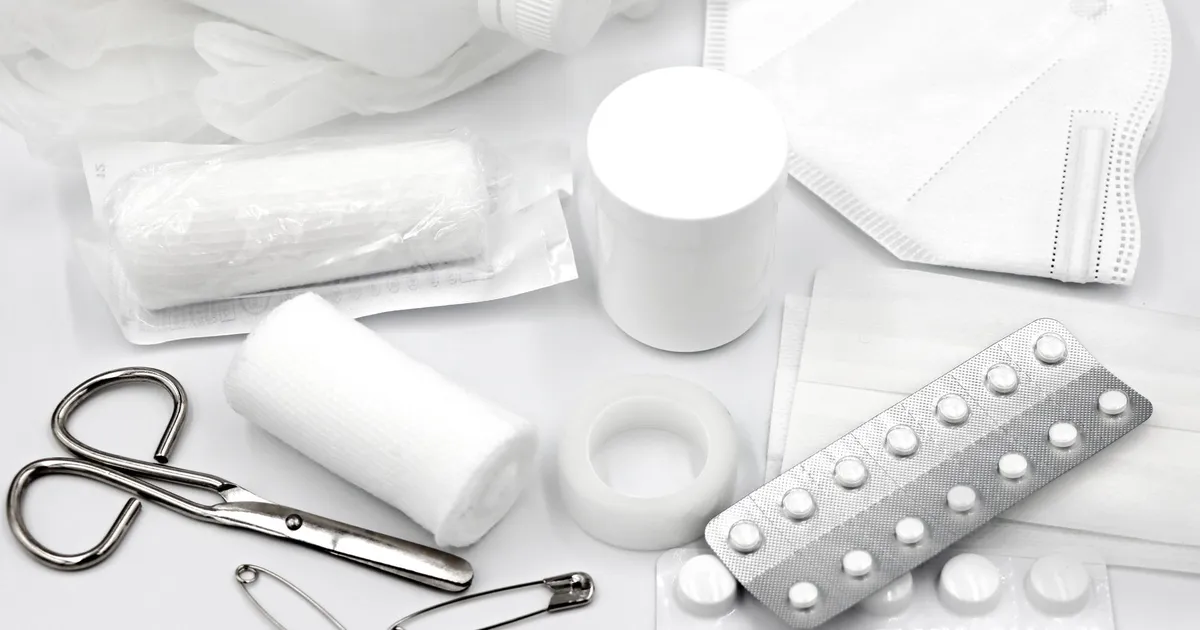 First aid supplies laid out on a white background