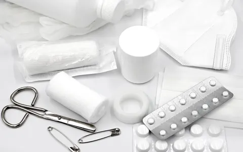 First aid supplies laid out on a white background