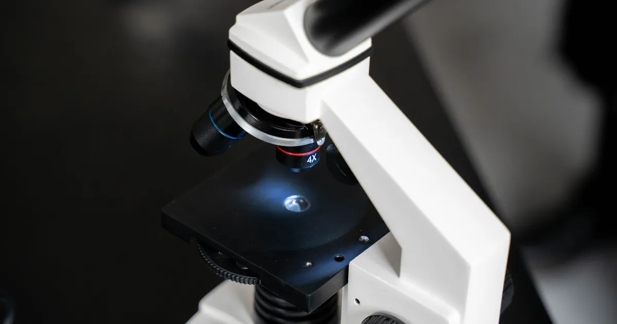 Close-up of a laboratory microscope with a blurred background
