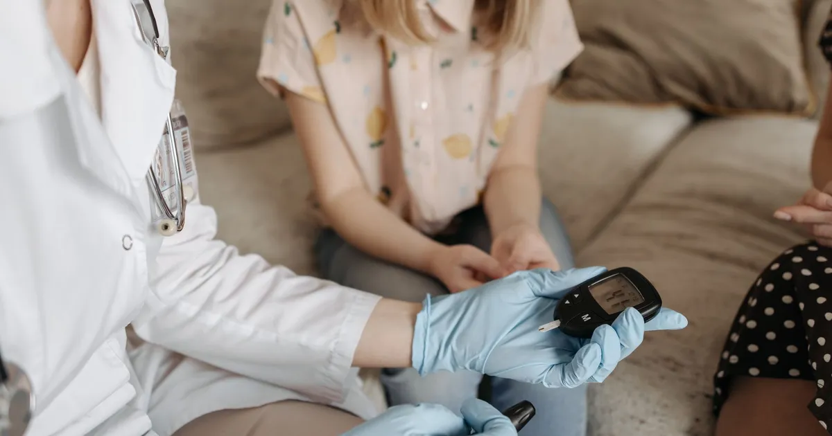 A doctor using a glucose meter to check a patient's blood sugar