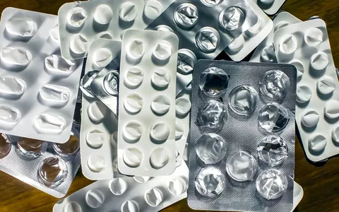 Close-up of empty medication blister packs on a wooden surface