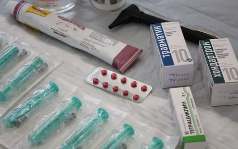 Medical supplies including syringes laid out on a surface