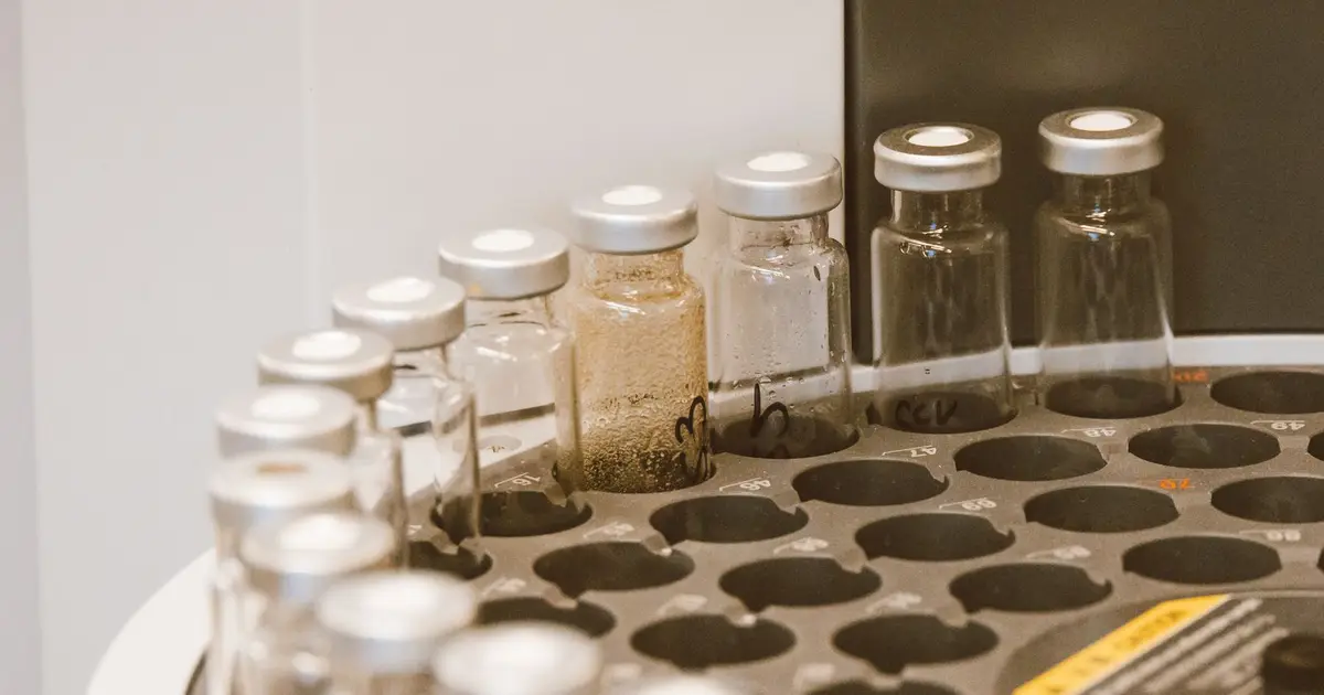 Glass vials arranged in a laboratory rack