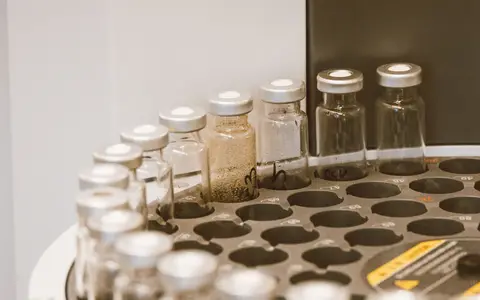 Glass vials arranged in a laboratory rack