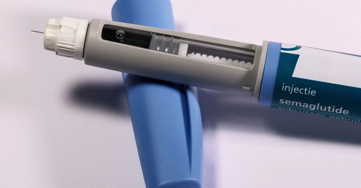 A blue injection pen lying on a neutral surface