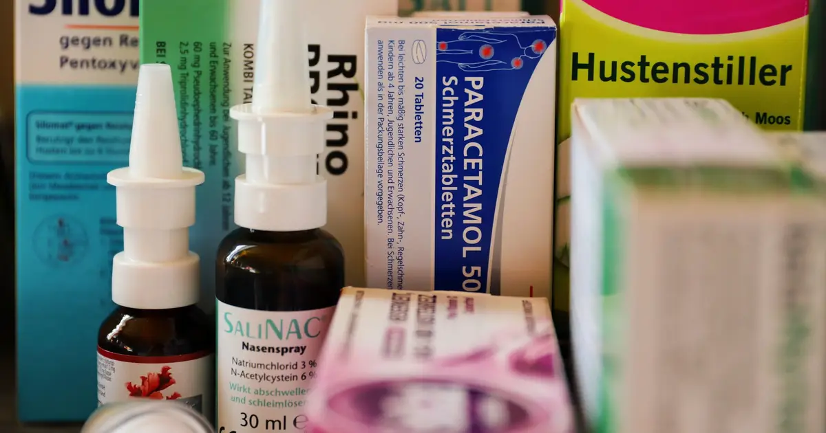 Assortment of cold and flu medications on a pharmacy counter