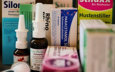 Assortment of cold and flu medications on a pharmacy counter