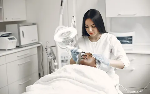 An aesthetician giving a client a facial treatment