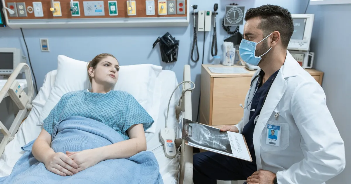 A medical practitioner discussing health details with a patient