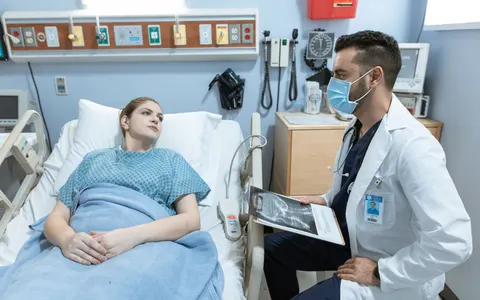 A medical practitioner discussing health details with a patient