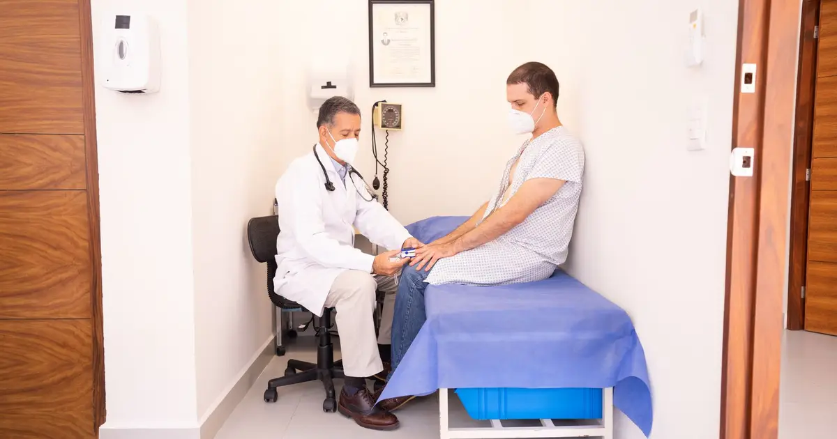 Doctor checking patient's vitals in a clinical setting for health consultation